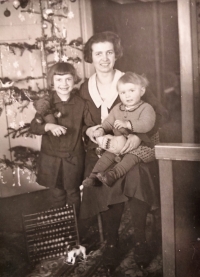 With mother and older sister Eliška