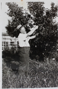 Father Josef Barton works in his orchard