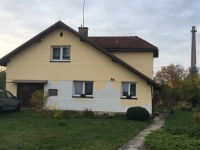 A house for employees, where the family was evicted in 1948. Květoslava Wodziková still lives there today. In the background, the factory chimney on the grounds of the Bartoň Yord factory, 2019