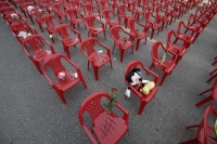 Empty chairs with favourite items of the killed people