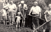 The Sedláček family on the hayride / Pavla Mikešová (left) with her younger brother, father (third from right), grandfather (second from right), mother (first from right) and other relatives / around 1961