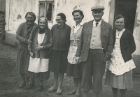 Mother and grandmother (left) with other displaced farmers