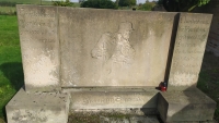 Inscription on the German soldier's tombstone (quoted from Heinrich Lersch's poem The Soldier's Farewell):

Nun lebt wohl! Menschen, lebet wohl!
Und wenn wir für euch und unsere Zukunft fallen,
soll als letzter Gruss zu euch hinüberhallen:
Nun lebt wohl, ihr Menschen, lebet wohl!
Ein freier Deutscher kennt kein kaltes Müssen:
Deutschland muss leben, und wenn wir sterben müssen!

Farewell, my friends, farewell!
And if we are to die for ourselves and the future,
our last farewell should be:
Farewell, my friends, farewell!
A free German knows not the coldness of obligation, 
Germany must live, even if we ourselves die!

Für Großdeutschland * fiel vor Warschau

Hermann Schneider
18. 5. 1919
21. 9. 1939

Er ruht bei feinen Kameraden, fein Geist ist um uns!

He fell for the sake of great Germany just off Warsaw
He rests surrounded by dear friends, gentle spirit sourounds us!

