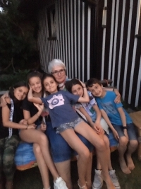 Ludmila Stáňová surrounded by grandchildren, 2019