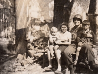 Roland Waclav as a child in the lap of an American soldier, Všeruby, May 1945