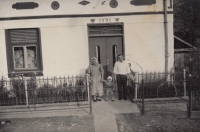 Mr. and Mrs. Bradáč in front of the repaired house in Gerník, undated