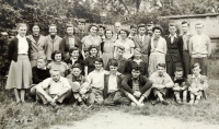 The witness (standing third from left) in the tenth grade in 1956, when the class rehearsed a Maypole performance