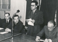 Father Walter Feldstein (standing), poet Jaroslav Seifert sitting behind the microphone, 1949