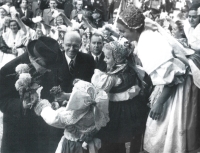 Zdenka Marie Nováková (left) gives a flower in her costume to President Edvard Beneš during his visit to Jičín in May 1945