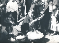 The ngillatún festival, the machi is resting and receiving refreshments from his female helpers