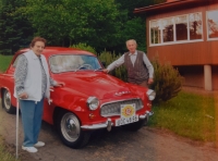 A witness with his wife by his car, around 2020