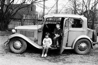 Children of a witness pose with an old Škoda car (model 420), spring 1968