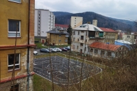 A view of the tower of the pseudo-Romanesque basilica in the direction from the housing estate and the railway line