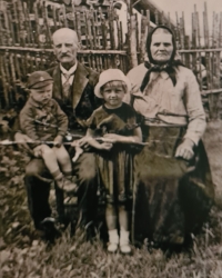 Marie Mikolášková with her grandmother and grandfather, second from the right, 1935