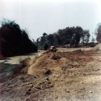 Dredging a water tank for soil washing during sapphire mining, Laos, 1985