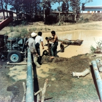 Sapphire mining, pump preparation, Laos, 1985