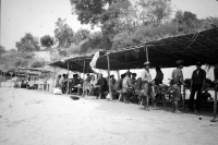 Work break with guards, Laos, 1985