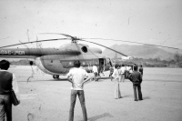 Preparing a helicopter for departure, Laos, 1986