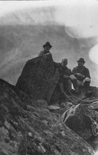 Witness with friends atop a rocky cliff