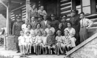 Olga Jaroňová (second from left, seated) with her father Josef Niesner (third from left, above) and other residents of the financial guard barracks in Dlhoň, Slovakia, around 1935