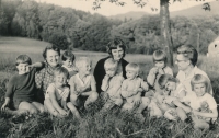 Pavla Paloušová (on the right in her father's lap) with her family and friends, ca. 1966. Adults from left: Heda Hejdánková, Dana Němcová and Jiří Němec