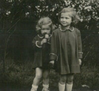 Left, with her older sister Dorota at her grandmother's house, Police nad Metují, 1955