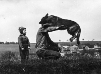 Arnošt Obrusník training a German Shepherd over Kozmice in 1965. On the left is the daughter Karla