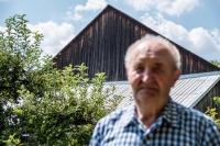 The barn behind Antonín Najser was built by his father when he was born, so they are both the same age