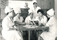 Mother as a canteen worker (with a magazine in her hand) surrounded by colleagues.