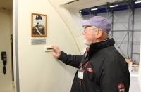 Igor Ocelka near a photo of his father at the door of the Airbus 319, which bears Ocelka's name, November 2017