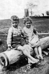 Karel Matuška with his friend Marie Pavlenková sitting on a wooden pump made by his father Josef