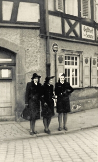 A photo of the witness (centre) with her friends from her stay in Germany - Jarka (left) and Hela (right), the two windows on the top right belonged to their rooms, 1944