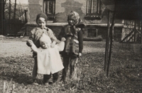 View of the house number 168 'on the playground' in Hradec nad Moravicí. In front of the house the Soudek siblings. Photograph was probably taken in the late 1940s