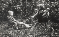 Lubomír Soudek sitting in a pram, his sister Rostislava Raidová with a doll. Photograph from the late 1940s