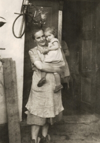 The third wife of the butcher Jakub Fajka - Františka Fajková, née Marethová, from Březová was the step-grandmother of Rostislava Raidová, née Soudková, whom he is holding in his arms in the photograph. The photo probably dates from 1944