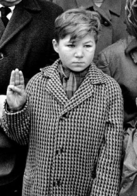 Vladimír Svoboda salutes Jan Palach during his funeral with a scout salute. Cropped from a photograph by Miloň Novotný