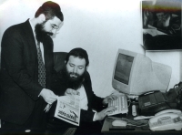 Discusing an issue of the Shomrei Shabbos newspaper. Odesa, the Chabad synagogue, 2002