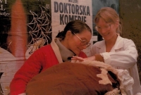 On the way from the maternity hospital with her newborn daughter Běta, Prague, January 1979