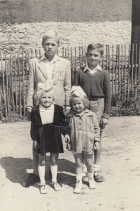 Petr Langr (left), his cousin Miluška standing in front of him, his cousin Maruška next to him and his younger brother Josef Langr standing behind him, 1952